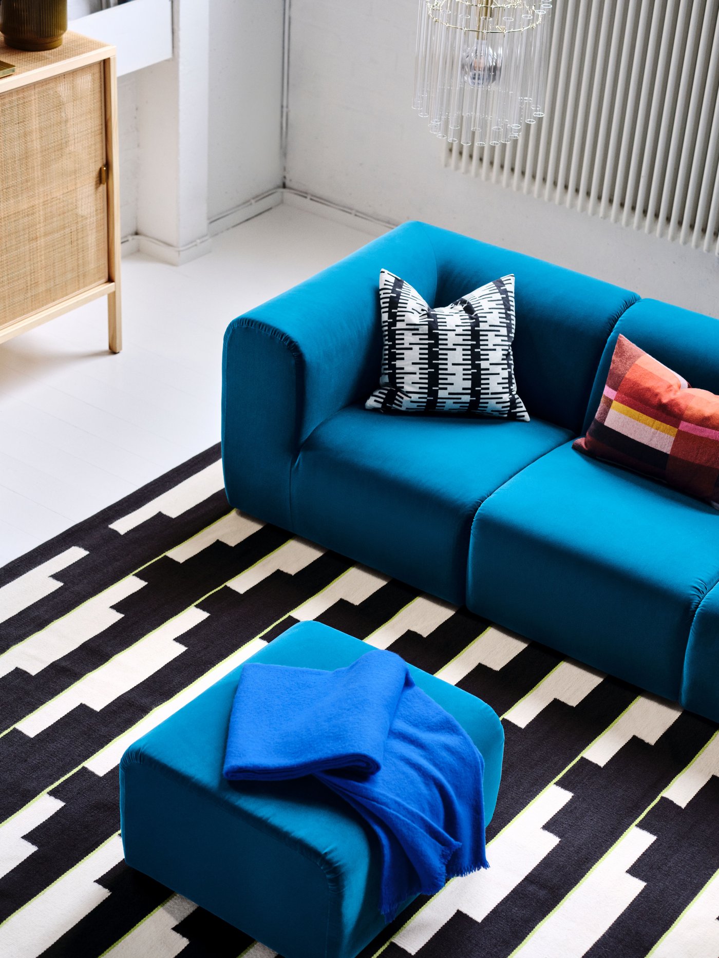A dark turquoise STOCKHOLM 2025 sofa with a footstool.