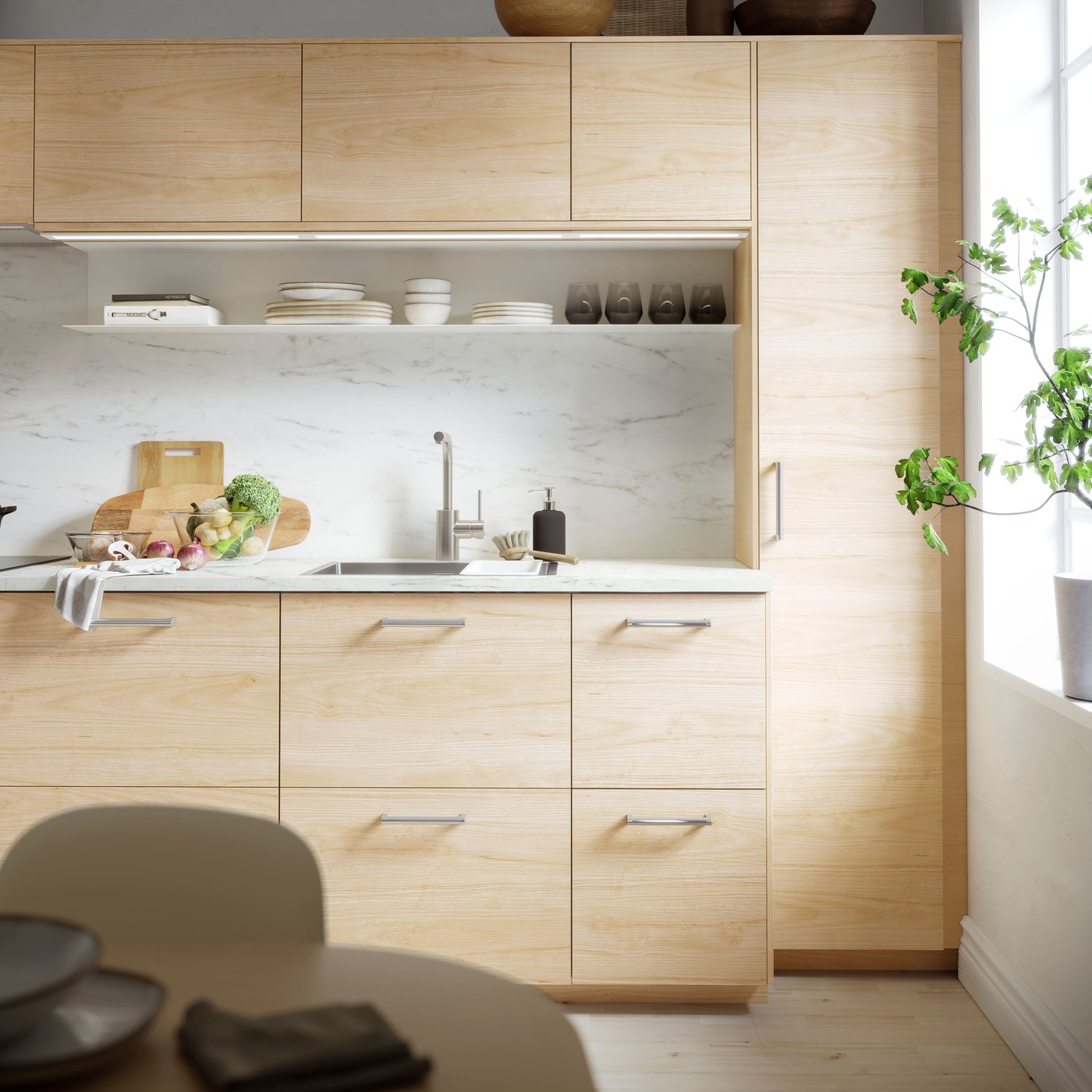 A light ash effect ASKERSUND drawer front in the kitchen