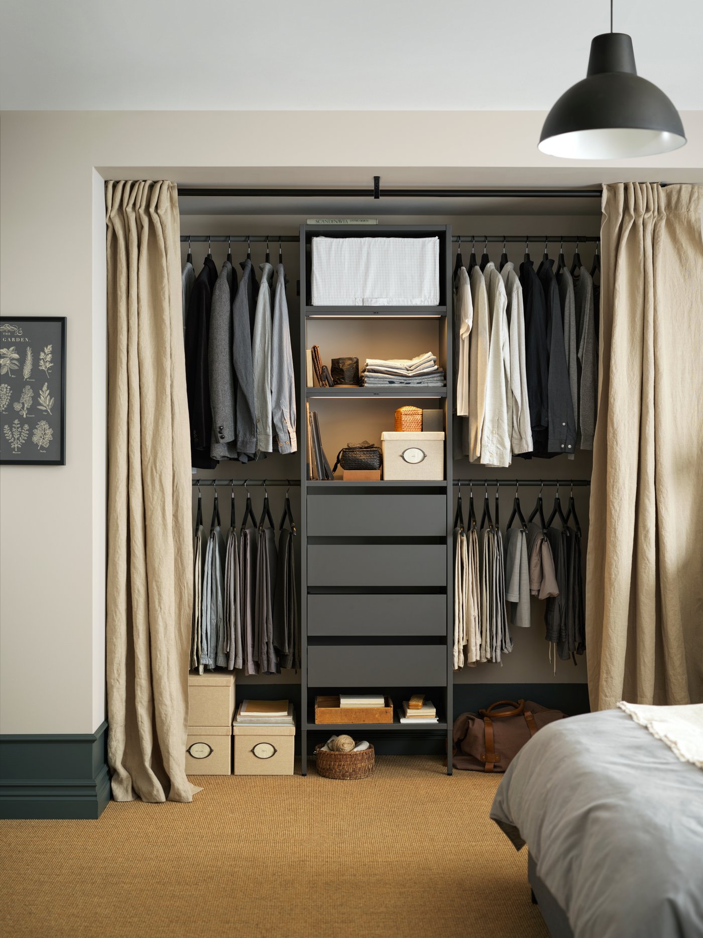 A black SKURUP pendant lamp in the bedroom, a black AURDAL reach-in closet in the back