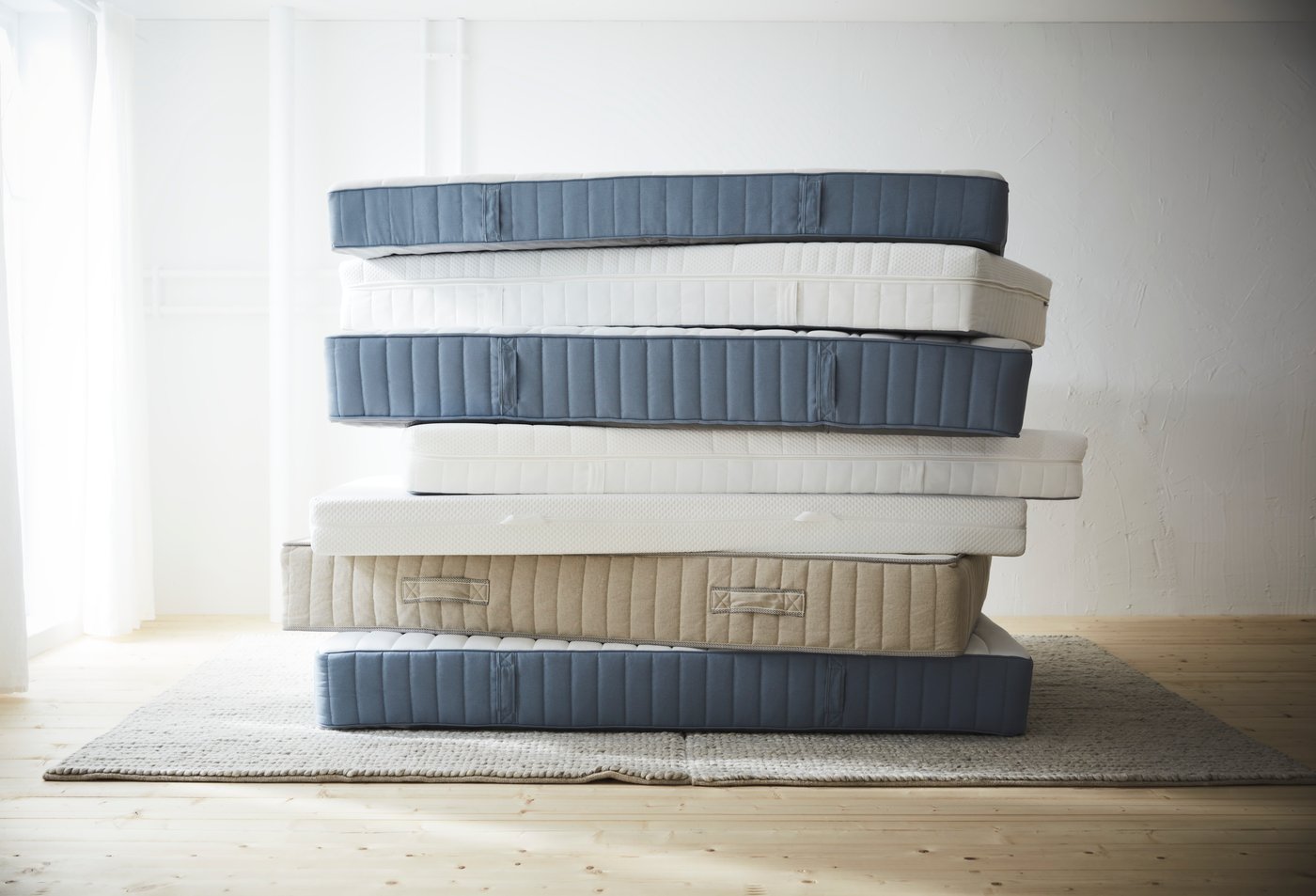 An extra firm/light blue VESTERÖY pocket sprung mattress in the bedroom