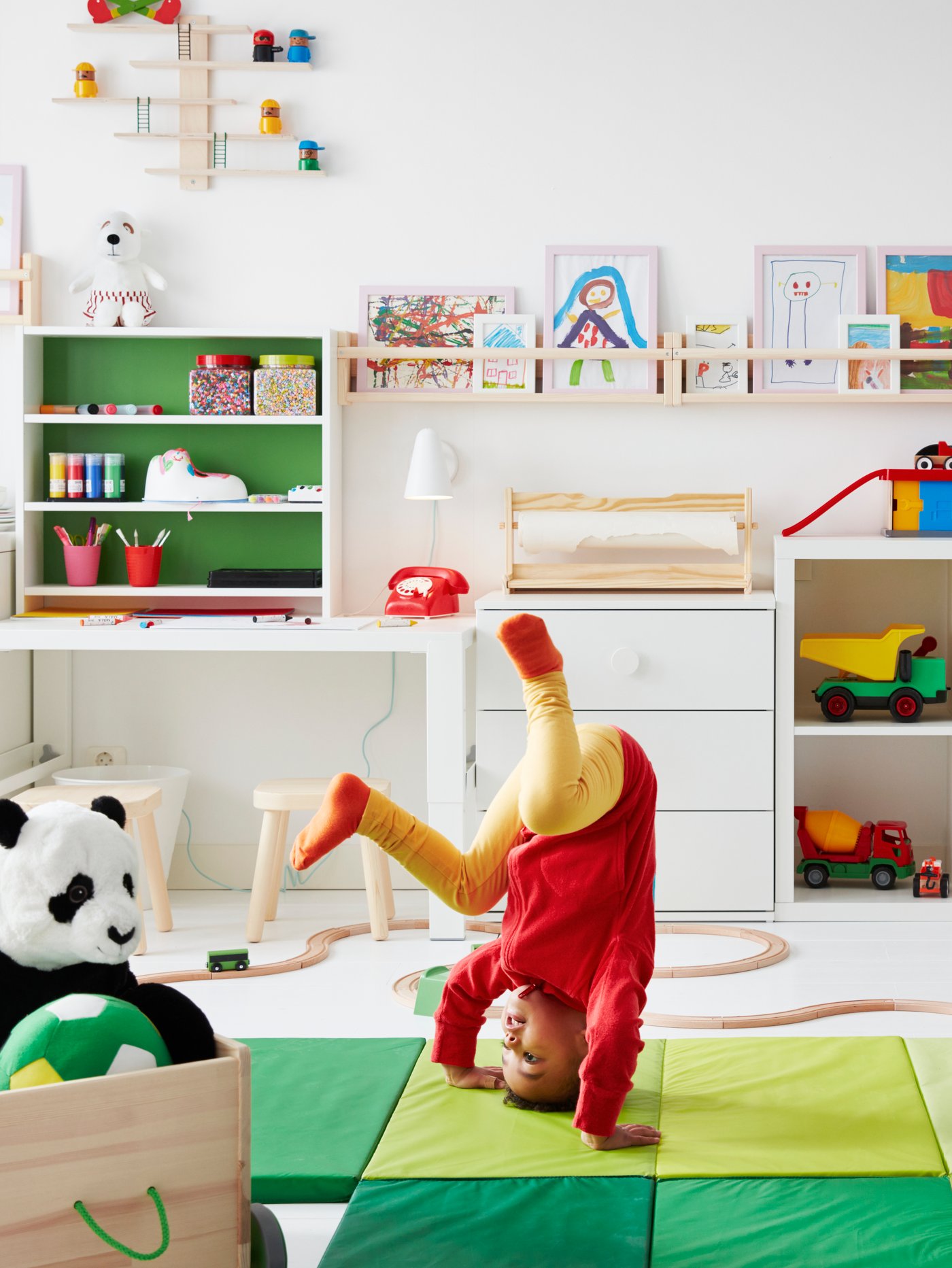 A light white stained pine FLISAT wall storage in the childrens room