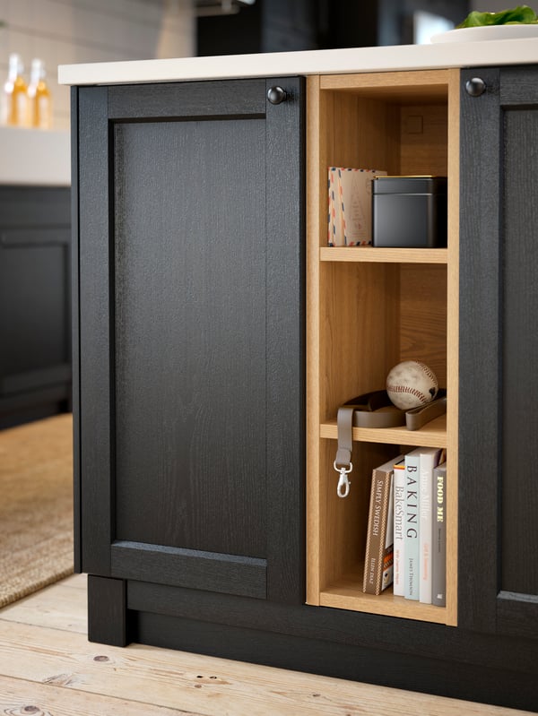 IKEA VADHOLMA open shelf unit in black/wood storing letters, cookbooks, and more.
