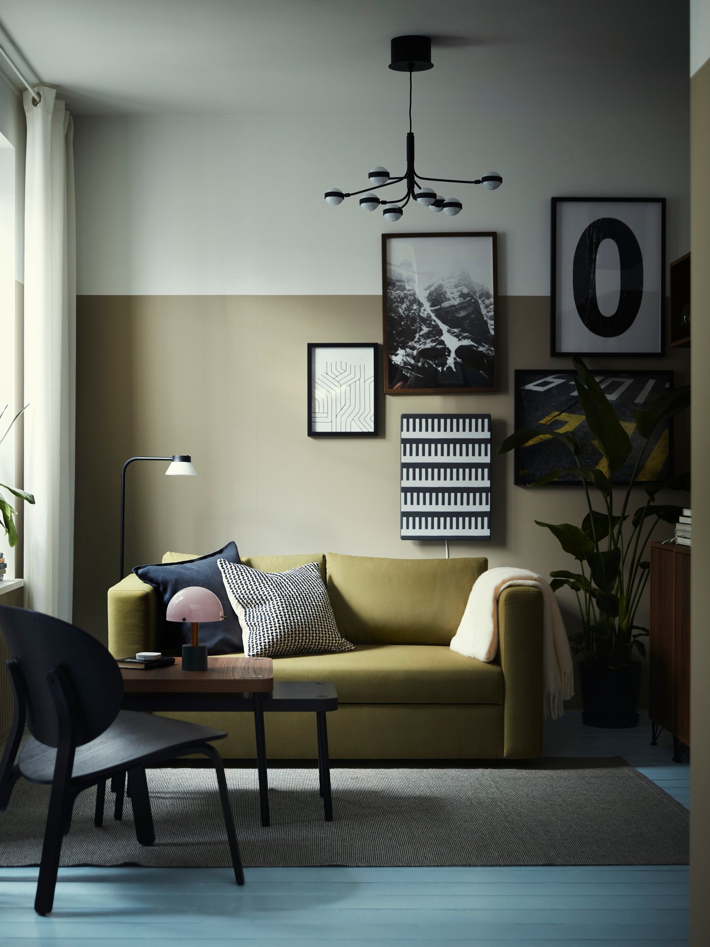 A set of 2 SONHULT nest tables and a FRÖSET easy chair stand in front of a SKÖNABÄCK 2-seat sofa-bed in a living room.