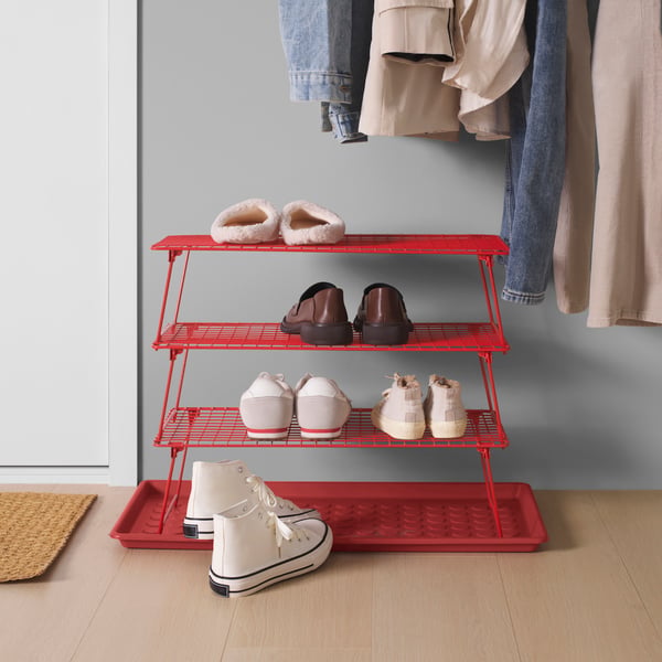 A bright red GREJIG shoe rack in the hallway