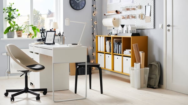 A white SKÅDIS pegboard for organized desk storage