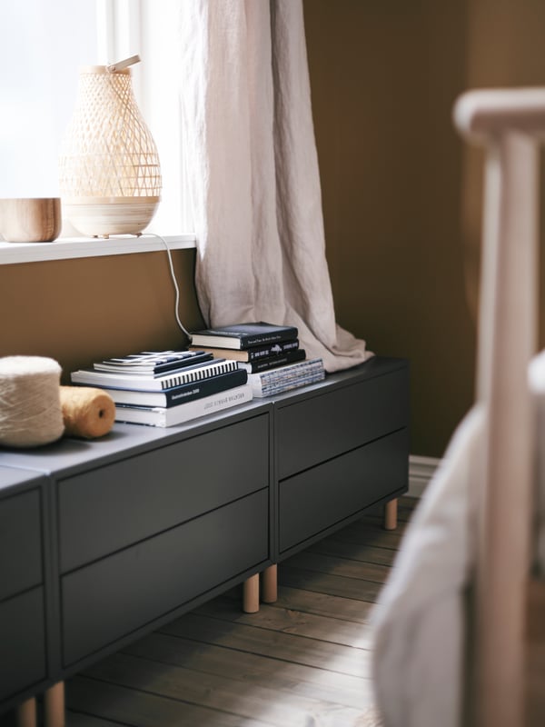 Three EKET cabinets turn the space below a low window into smart extra storage.