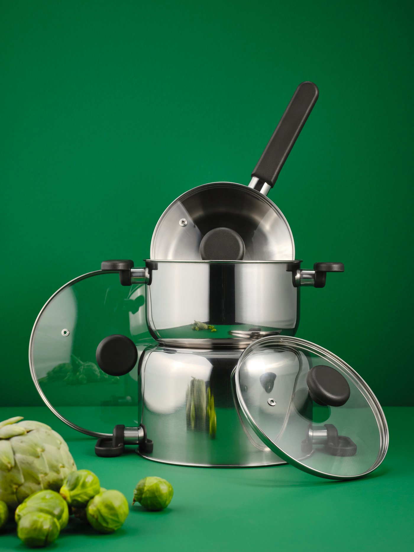 A clear glass/stainless steel MIDDAGSMAT saucepan with lid