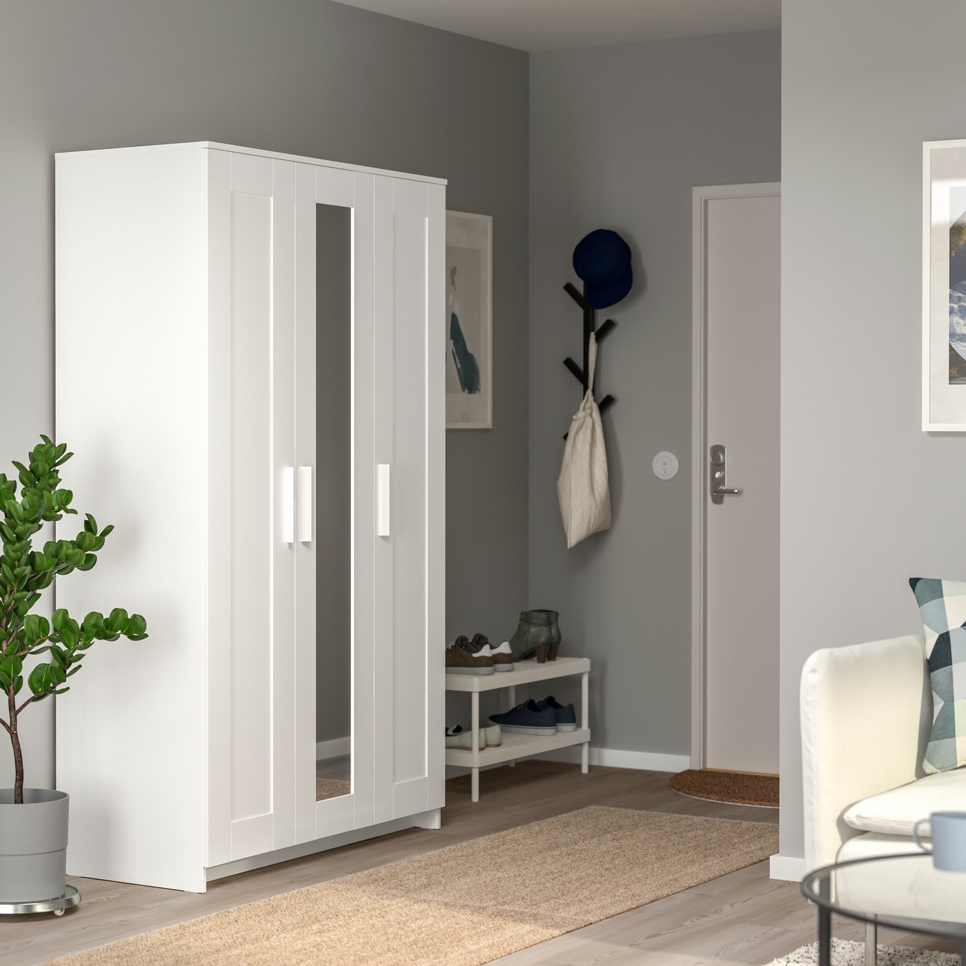 A white BRIMNES wardrobe with 3 doors in the hallway