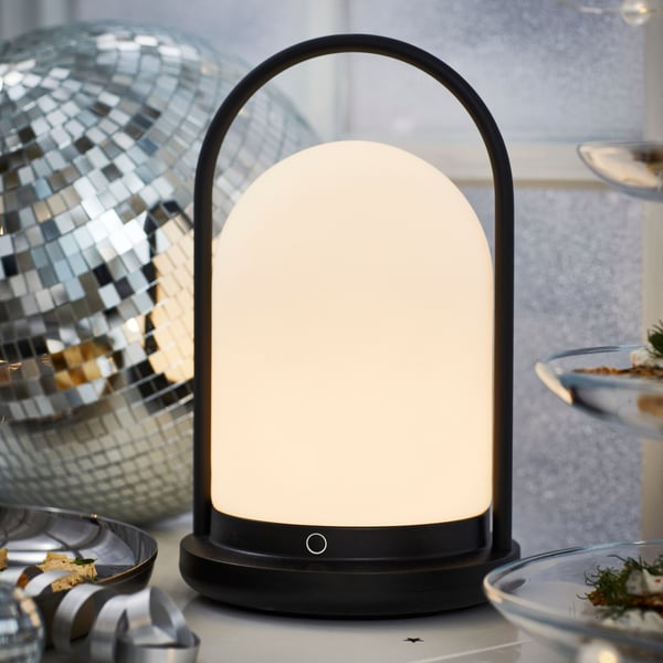 A battery-operated outdoor/dimmable black FRÖJDA LED lantern