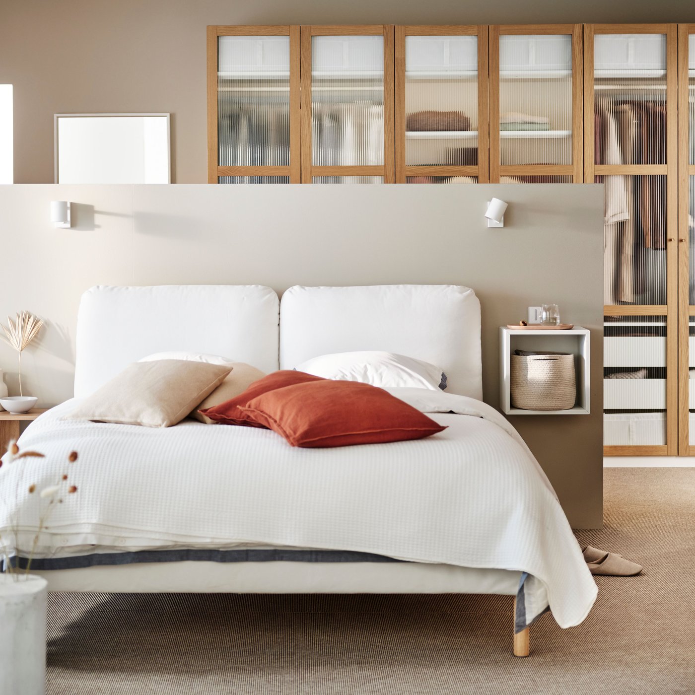 A Gräsbo white SAGESUND upholstered bed frame in the bedroom