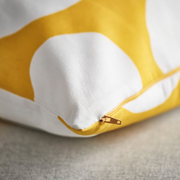 Yellow cushion cover with white dots, quality zip, recycled fabric detail.