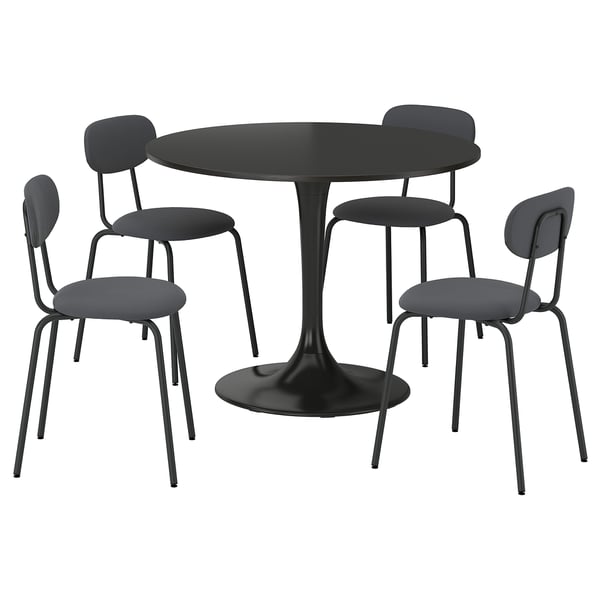 Black round table and grey chairs, modern design with metal frames.