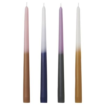 Four colourful tapered candles in brown, blue, green, and beige with fading colours, standing upright.