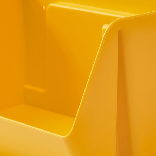Bright yellow plastic storage organiser, smoothly curved edges, clean, modern design, wall-mountable.