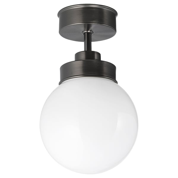 The FRIHULT lamp, matte black, a spherical glass shade and sleek metal base, creating a vintage yet modern design ideal for lighting and ambiance.