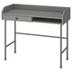 A grey HAUGA desk with a modern design. Made of metal and wood, it a tabletop, drawer, and open compartment, offering workspace and storage.
