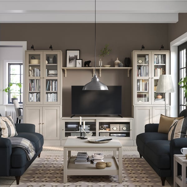 Grey living room with sofas, rug, tv unit, decor, lamp, window, cosy vibe.