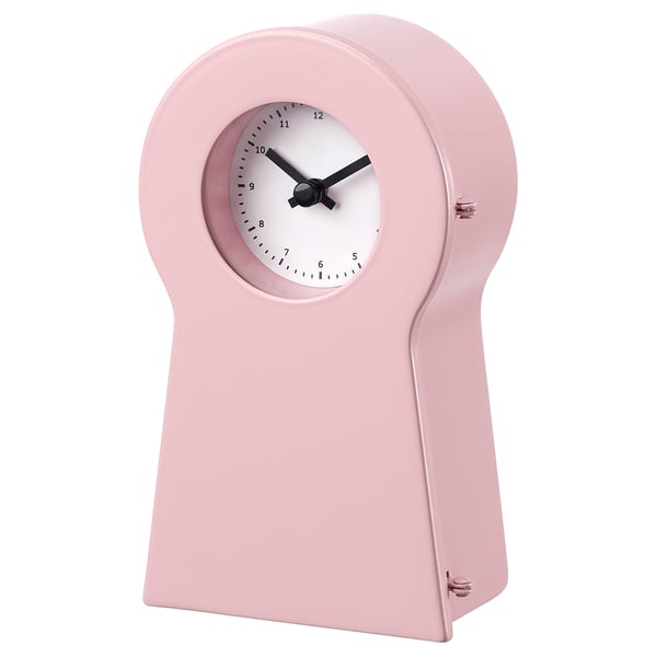 A pink IKEA PS 1995 clock. It has a sleek, modern design with a round face and glass front.
