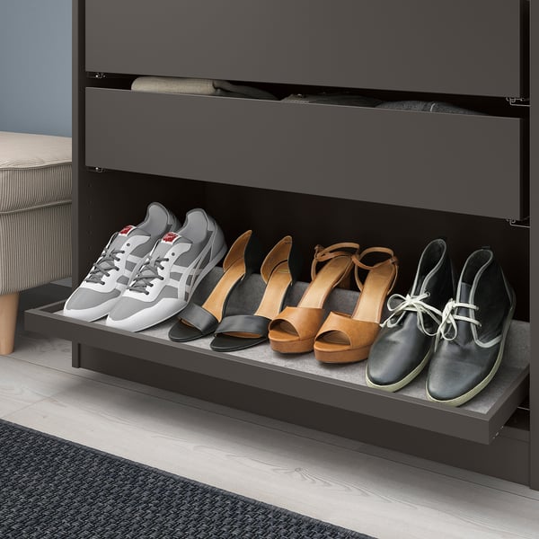 Black shoe organiser with grey felt lining, storing various footwear types, including trainers, heels, and boots.