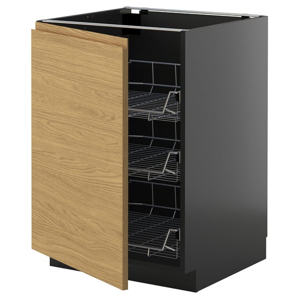 A modern black kitchen cabinet with wooden door, wire racks inside.