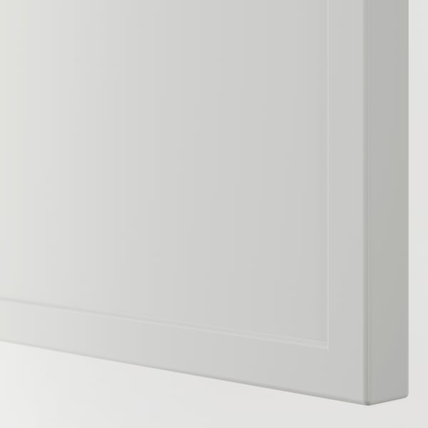 Close-up of a pristine white, modern framed furniture corner, showcasing its sleek and polished finish.