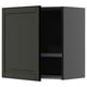 Dark green wall-mounted kitchen cabinet with one door open, revealing wire dish racks inside.