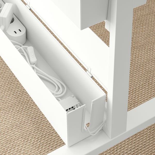 A modern MITTZON wall divider with cable management, featuring a compartment with an electrical setup and organised cords for easy use.