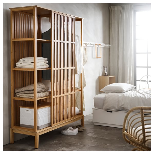 NORDKISA bamboo wardrobe with open shelves and sliding door, natural colour, in minimalist bedroom setting.