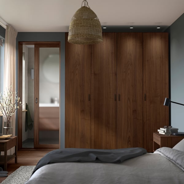 Modern bedroom with PAX wardrobe, bed, side table, and pendant lamp.
