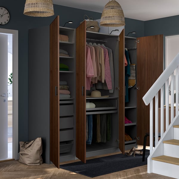 Modern hallway wardrobe with open doors revealing clothes, shelves, and hanging space. It has adjustable feet and built-in lighting.