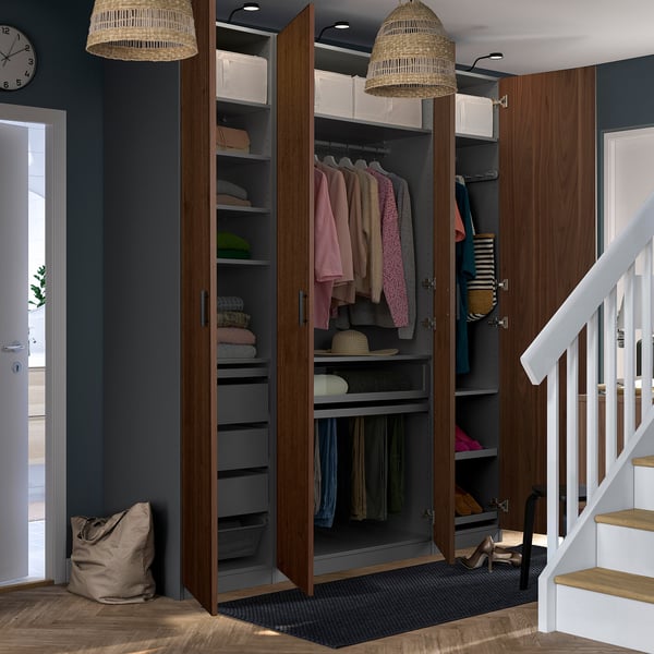 Modern entryway with storage closet, shoe rack, & pendant lights. Staircase to right.