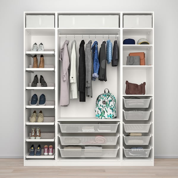 Organised closet with hanging rack, shelves, and baskets.