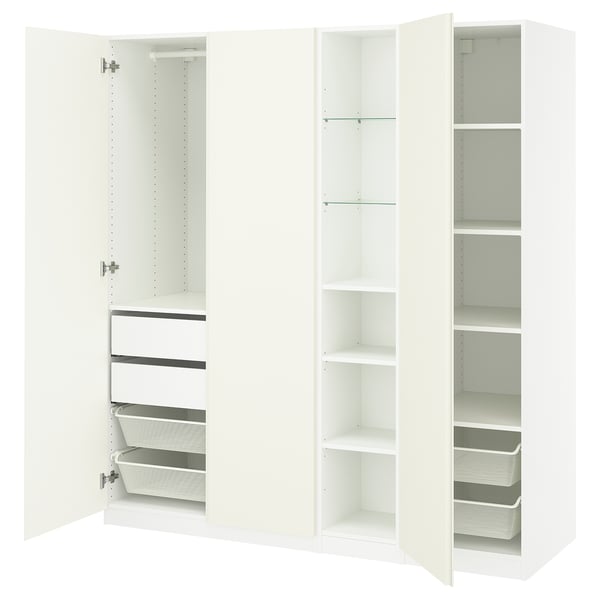 White PAX wardrobe, open showing shelves, drawers, baskets. Modern, minimalist design for organised storage.