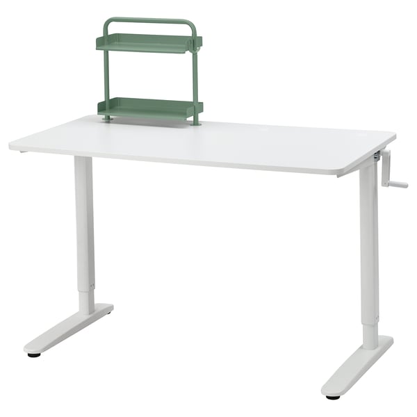 Adjustable RELATERA desk with green shelf, sits/stands.