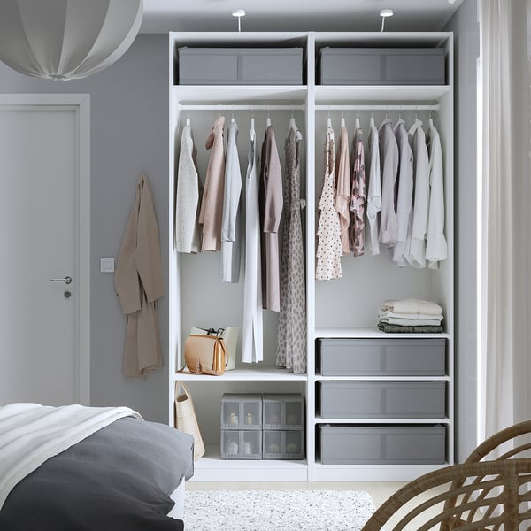 Modern bedroom with open wardrobe, neat clothes, and clear storage.