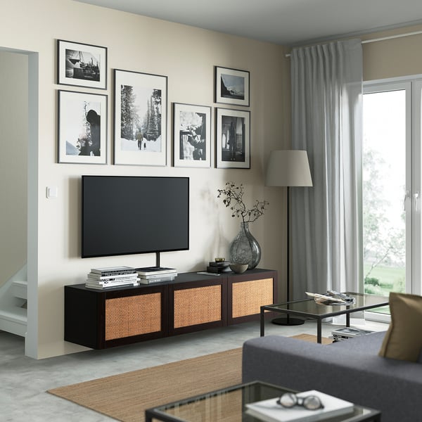 Modern living room with STUDSVIKEN tv unit, wood accents, and large flat screen tv. Glass coffee table, grey curtains.