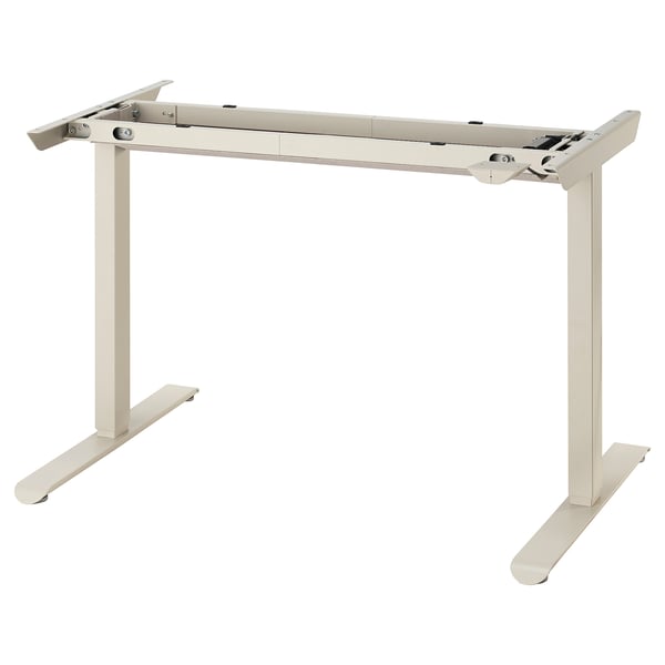 A beige TRAVSPORT adjustable desk base with metal legs and a control panel.