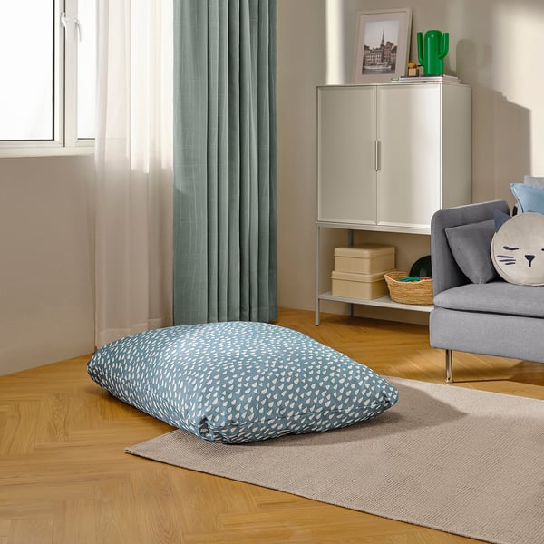 Living room: dog bed, cat pillow, plant & framed pic.