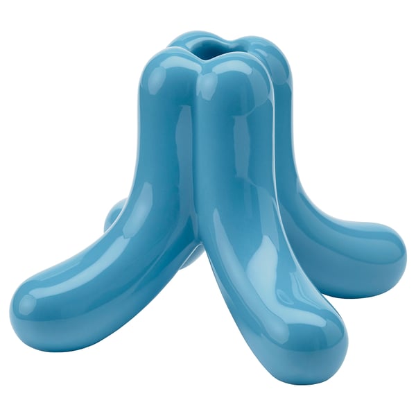 Blue ceramic decorative item, abstract design with four curved legs and smooth finish.
