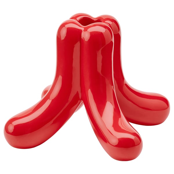 Bright red ceramic sculpture with five elongated, curved arms extending outward, resembling a stylized starfish or abstract design.