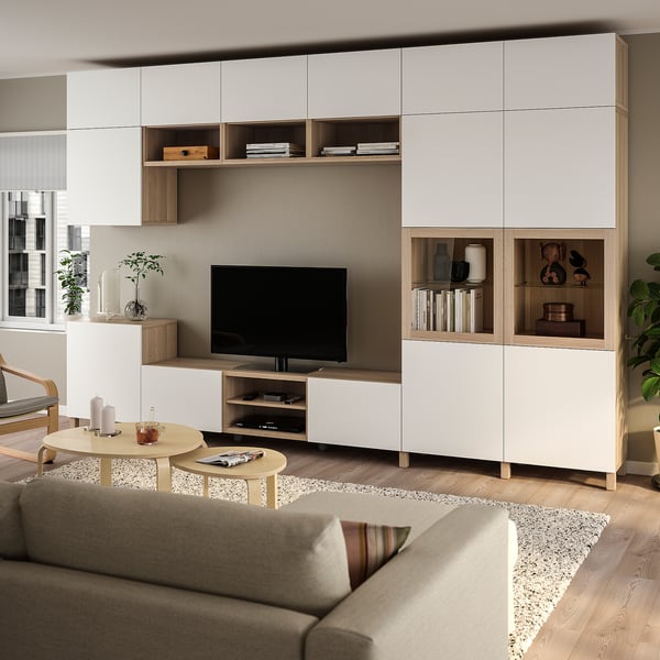 Modernt vardagsrum med förvaring BESTÅ i vitt och ljust trä. Stor tv-avdelning, glasdörrar och minimalistisk inredning.