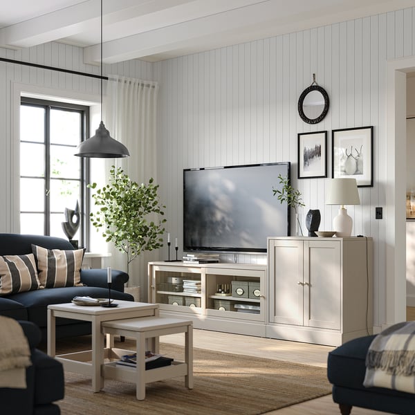 Modernt vardagsrum med HAVSTA tv-möbel i ljust trä, med platt-tv, inredning och blå soffa. Ren, minimal design med naturliga element.