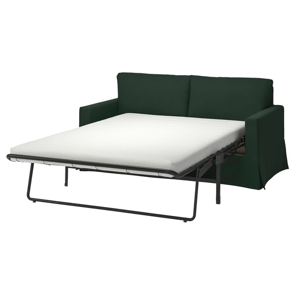 Grön HYLTARP bäddsoffa, modern design, med metallben och vit madrass, delvis utdragen.