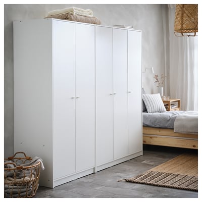 Modernt minimalistiskt sovrum med vita KLEPPSTAD-garderober, vävda dekorationer och neutrala sängkläder.