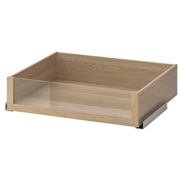 Lådan KOMPLEMENT, ljusbrun i trä, front i glas.