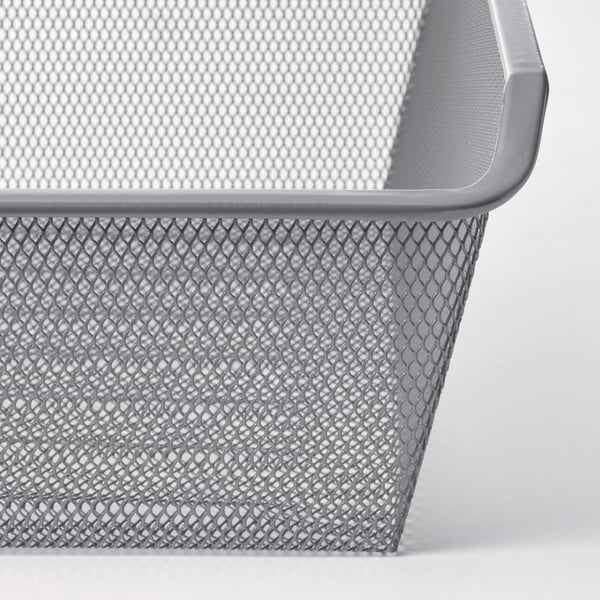 Närbild av en grå metallnätkorg. Visar intrikata diamantmönstrade hål och släta kanter, vilket framhäver kvalitet och design.