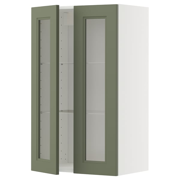 Ett grönt METOD-köksskåp med glasdörrar och en vit ram som erbjuder en modern design och justerbara hyllor.