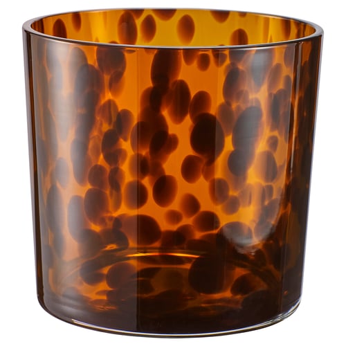 Ullsyre glaskruka: rund, brun med svarta fläckar, klart glas, växthållare, elegant design.