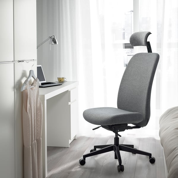 Modern ergonomisk VALLFJÄLLET kontorsstol nära skrivbord med laptop och mugg.