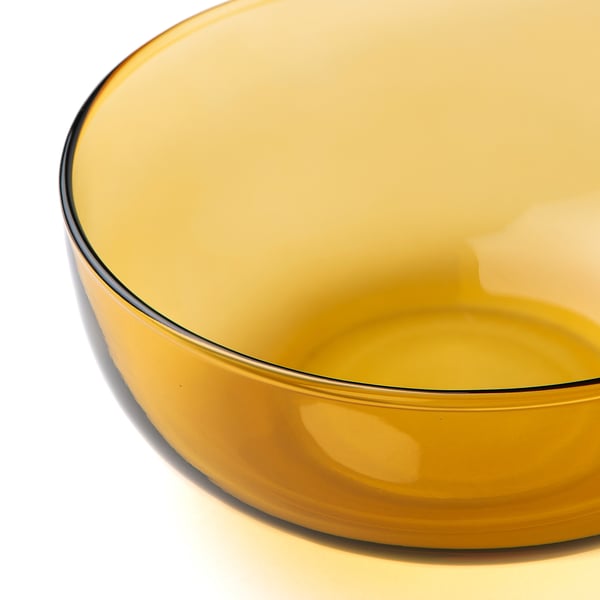 Amber glass bowl, thin rim, smooth finish, mouth-blown craftsmanship.